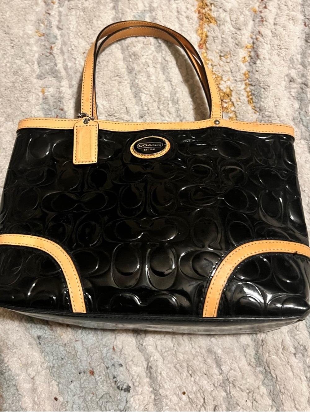 Coach Peyton Black Patent Tote with Tan Trim and Signature Plaque.